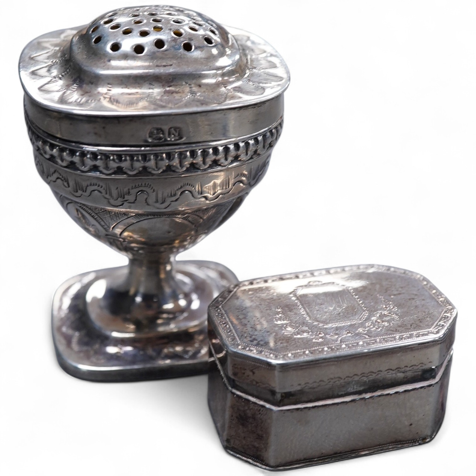 A George III silver octagonal nutmeg grater by Phipps & Robinson, London, 1810, 46mm(a.f.), together with a George III silver pedestal pepperette, by Alice & George Burroughs, London, 1808, 70mm.